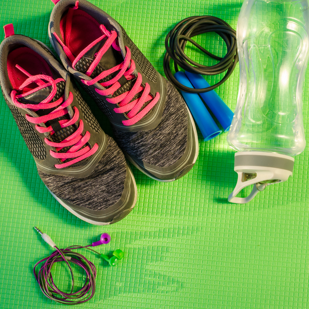 gym sneakers, water bottle, jump rope, and headphones, placed on a green background