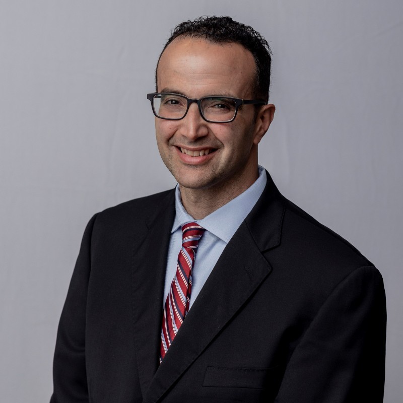 Joaquin Ramos headshot in suit and tie