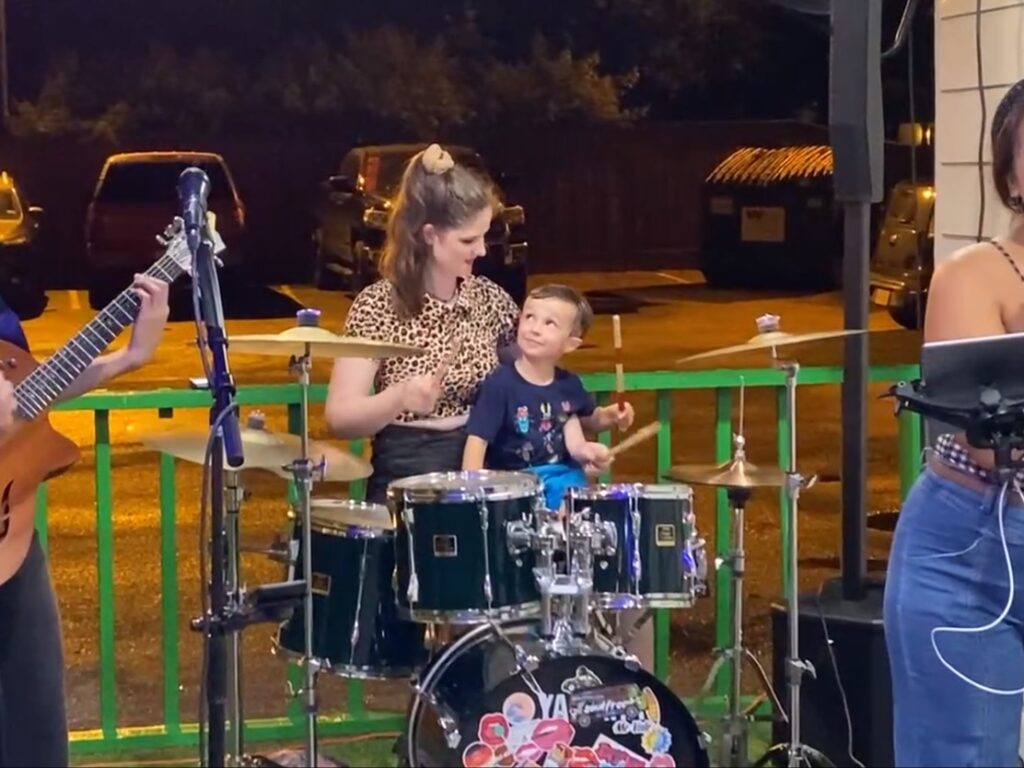 Bella pictured at her drumset with her cousin Emerson