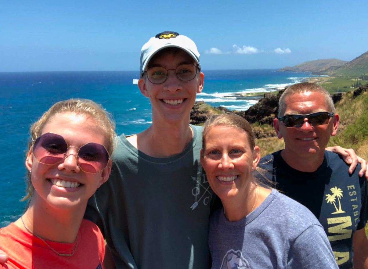 Andrew Rankins and family pictured in front of a body of water