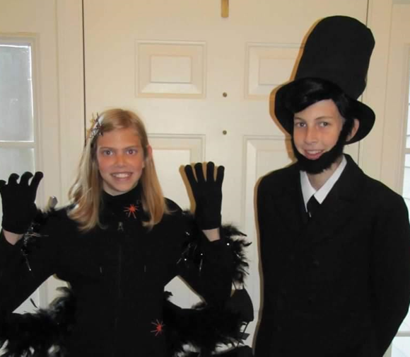 Andrew and his sister in costumes as children. Andrew is dressed as Lincoln.