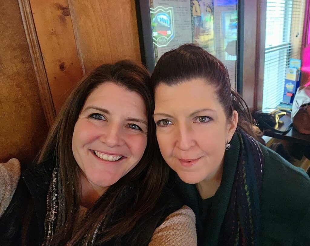 Jeanette and her late sister Stephanie are pictured cheek-to-cheek smiling warmly. Stephanie's death due to Marfan syndrome saved Jeanette's life and their mother's life. 