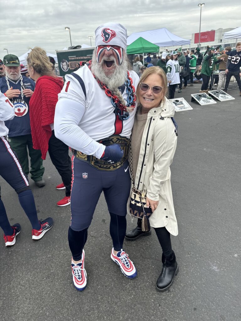 Deputy Executive Helaine Baruch with Steve Beckholt. Steve is dressed in his ultimate fan gear.