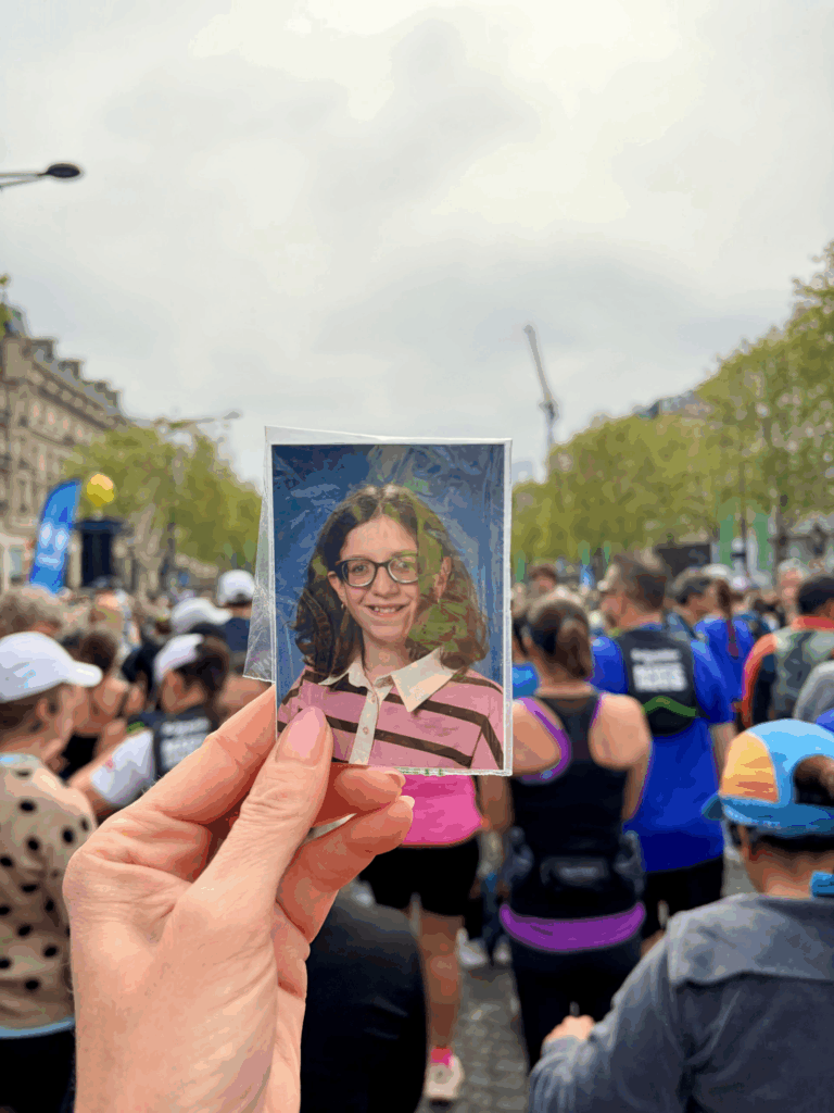 A picture of Nora is held up at the Paris Marathon. Team Nora ran for a young woman with Marfan syndrome. 
