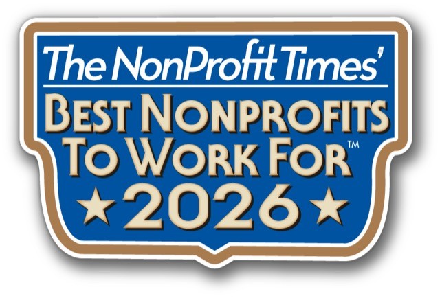 Logo for The NonProfit Times' Best NonProfits to Work for 2026. The 2026 is offset by gold stars, text is gold against blue background. White title. Gold outline.