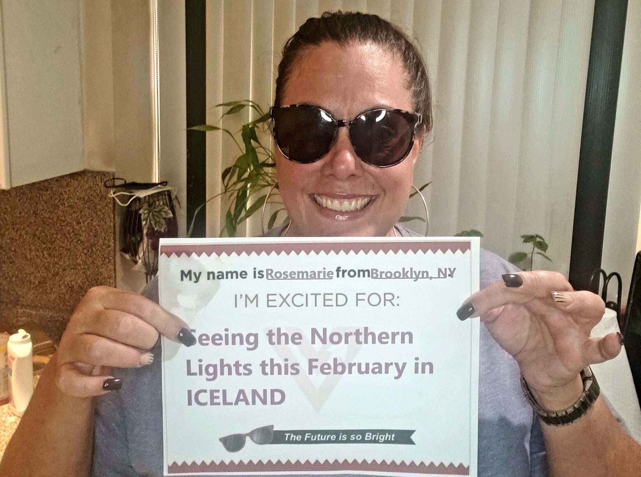 Roe Nania pictured in sunglasses smiling holding up a Northern Lights goal.