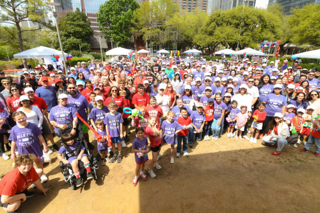 Large group poses in WFV tees and REDS VEDS shirts at 2026 Houston WFV.