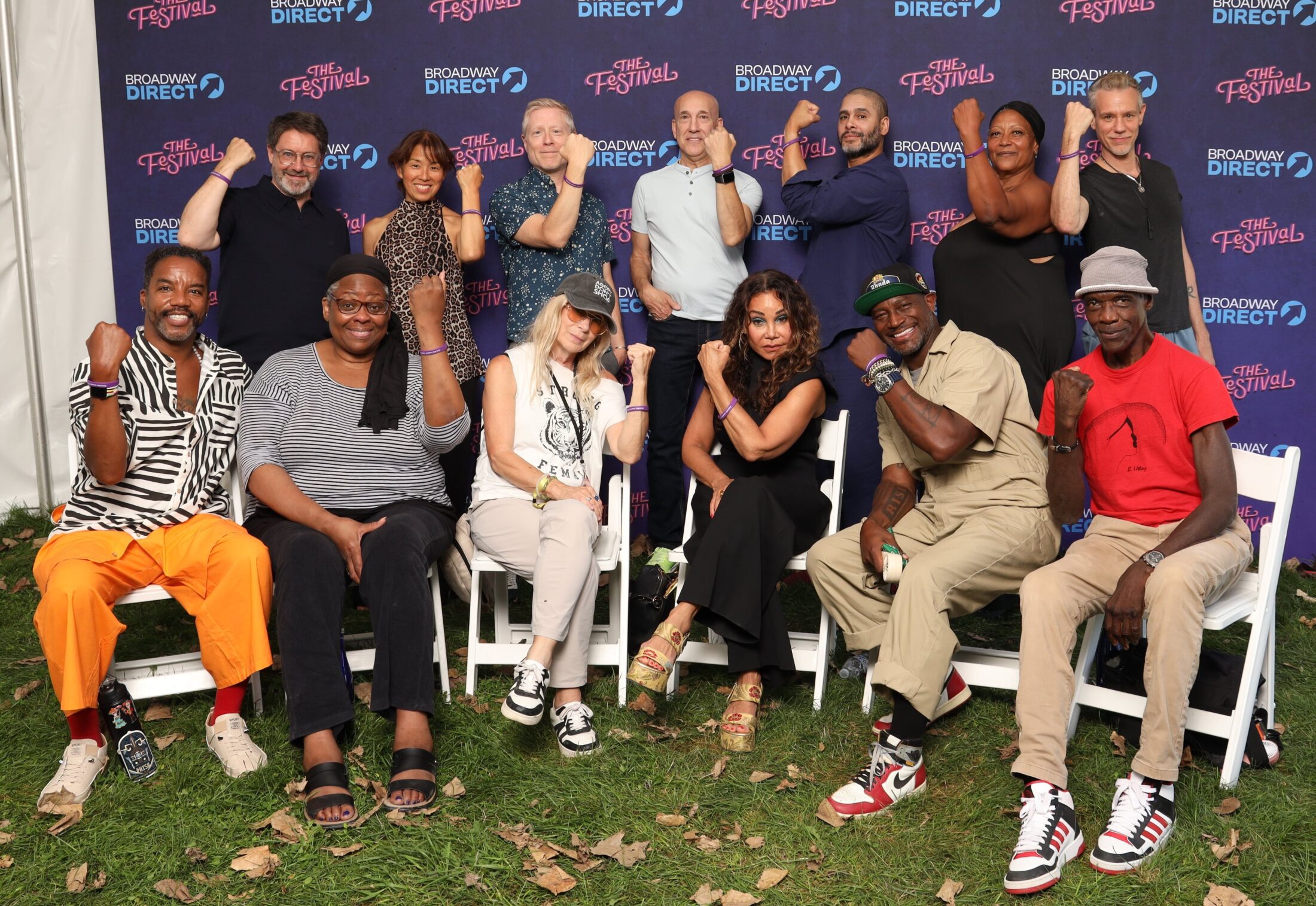 Rent cast pictured at 30th reunion wearing Jonathan Larson Marfan purple awareness bracelets, arms raised