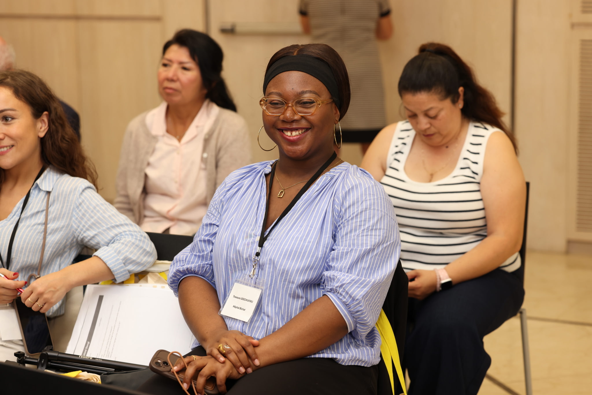Participant in the Marfan Foundation's 2026 Science in Spain in Barcelona smiles from the audience during the sessions.